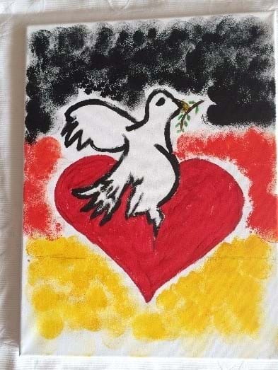 Taube mit Herz. Im Hintergrund Deutschlandflagge