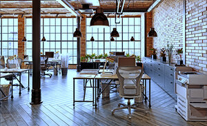 Gemeinschaftsbüro mit mehreren Schreibtischen und großen Fenstern